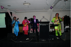 Dr. Jenson Mak entertaining the crowd with his rendition of the classic 'Hey Jude' with the Beatles Tribute Band 'Beatles Magic' at Crystal Palace marking the 20th Anniversary of the ACMA Charitable Trust.